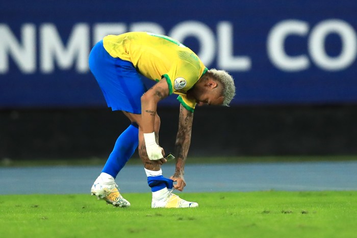 Why do pro footballers cut their socks?