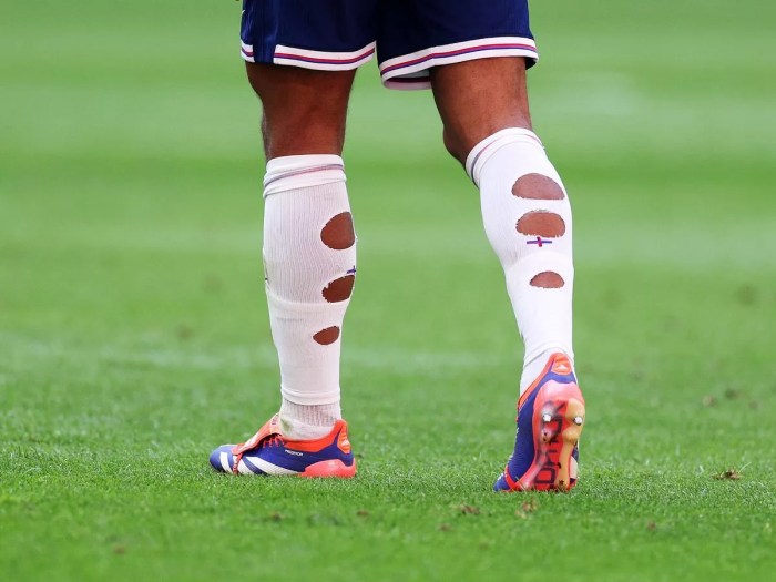 Why do pro footballers cut their socks?