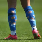 Why do pro footballers cut their socks?