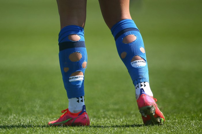 Why do pro footballers cut their socks?